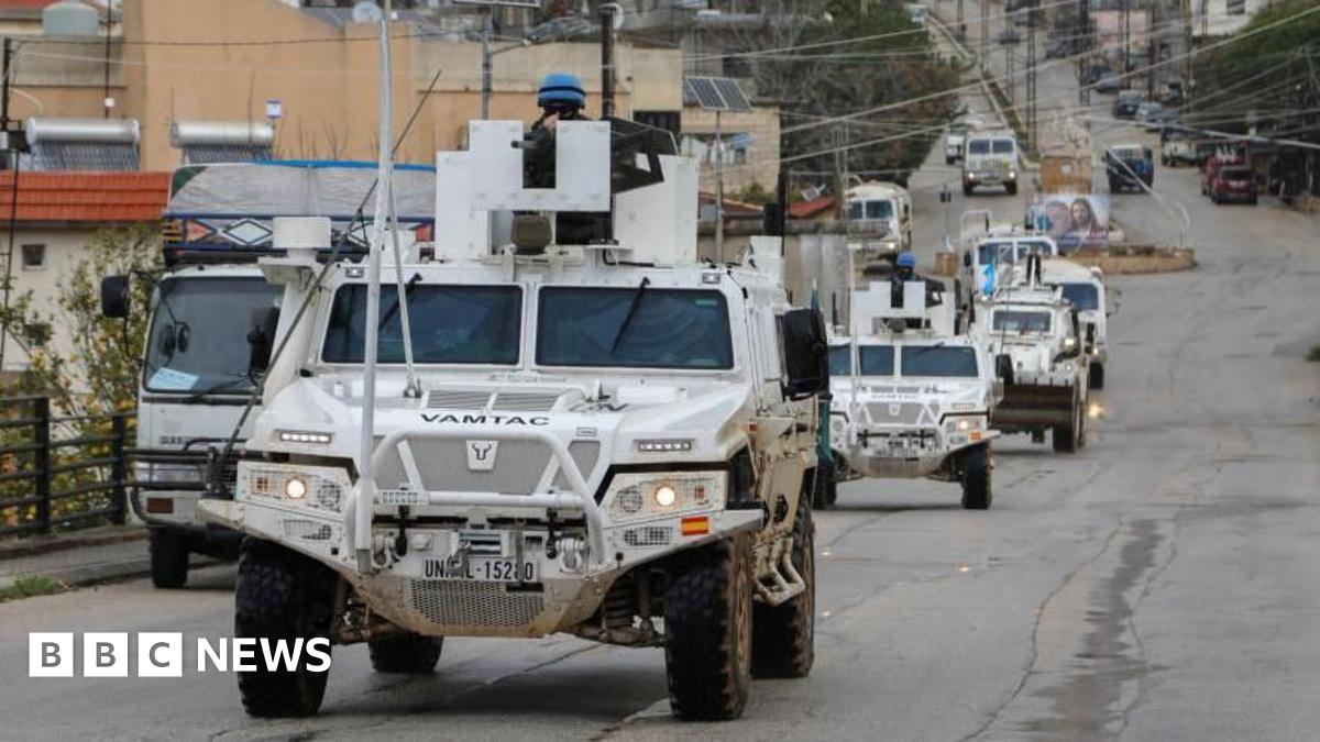 White UNIFIL vehicles drive on a main road in Qlayaa, amid escalating hostilities between Israel and Hezbollah