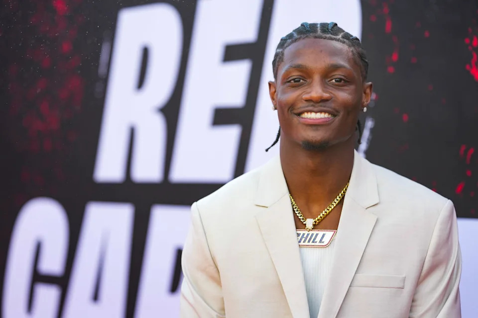 Ohio State wide receiver Carnell Tate poses for a photo on the red carpet for the 2026 NFL Draft in Pittsburgh wearing a necklace that says Chill. 