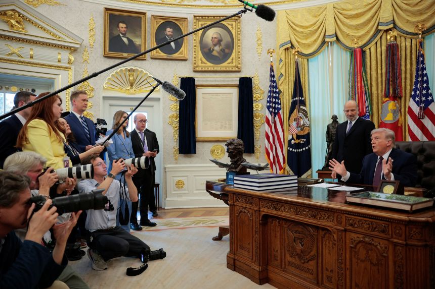 President Donald Trump speaks next to Commerce Secretary Howard Lutnick, during the signing ceremony for an executive order on mail-in ballots, in the Oval Office of the White House on March 31, 2026.