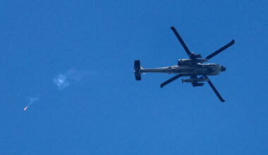 An Israeli Apache helicopter releases a flare as it flies over the border with Lebanon