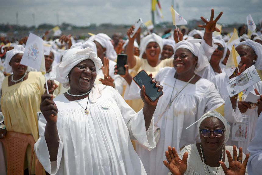 Faithful attend a holy Mass celebrated by Pope Leo XIV near the Japoma Stadium on Friday.