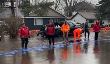 Volunteers, city staff working amid downpour to stem floodwaters