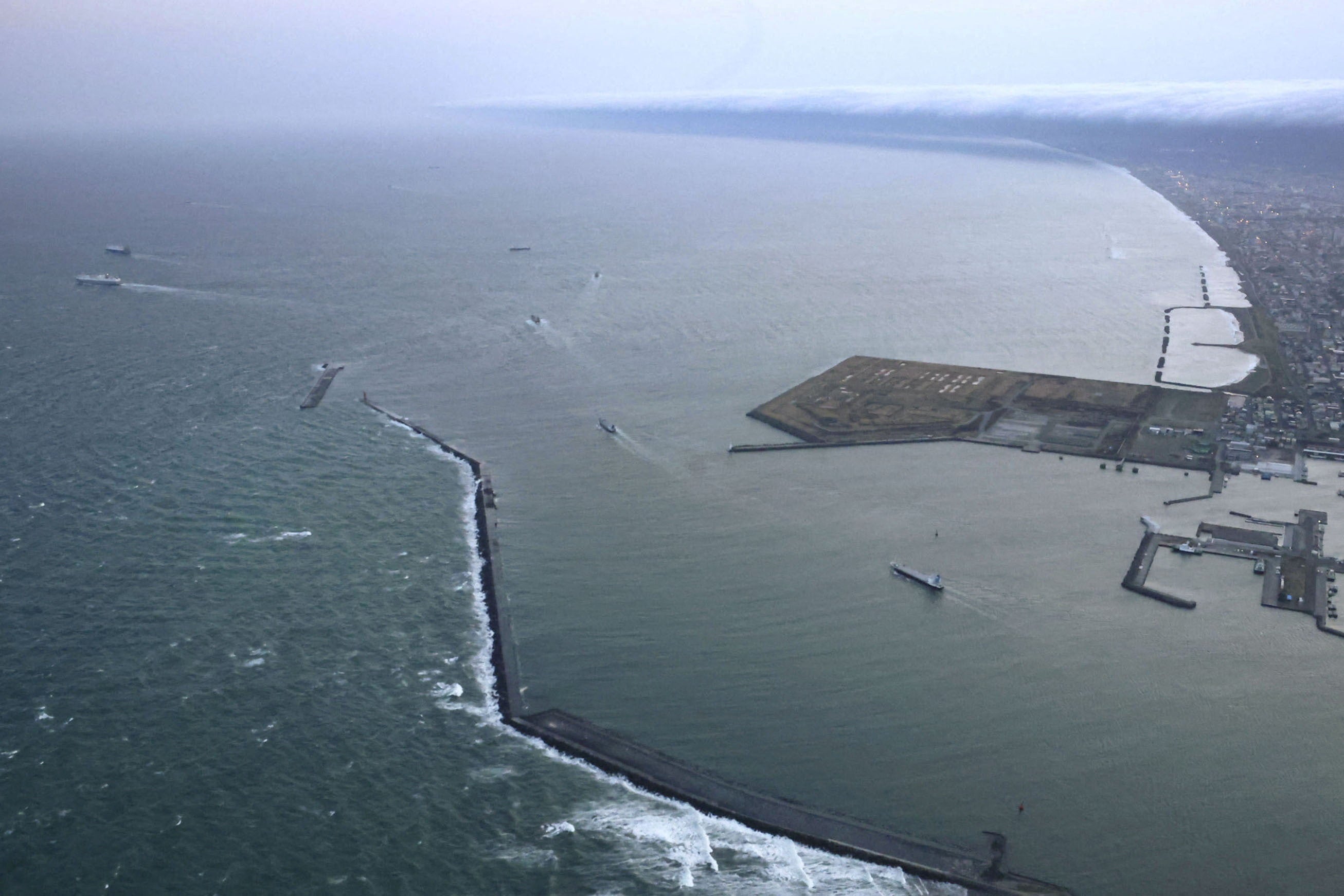 Vessels depart a port in Tomakomai, Hokkaido Prefecture, Japan, where a tsunami warning was issued following an earthquake