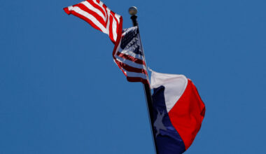 FILE PHOTO: The U.S flag and the Texas State flag fly over the Texas State Capitol in Austin
