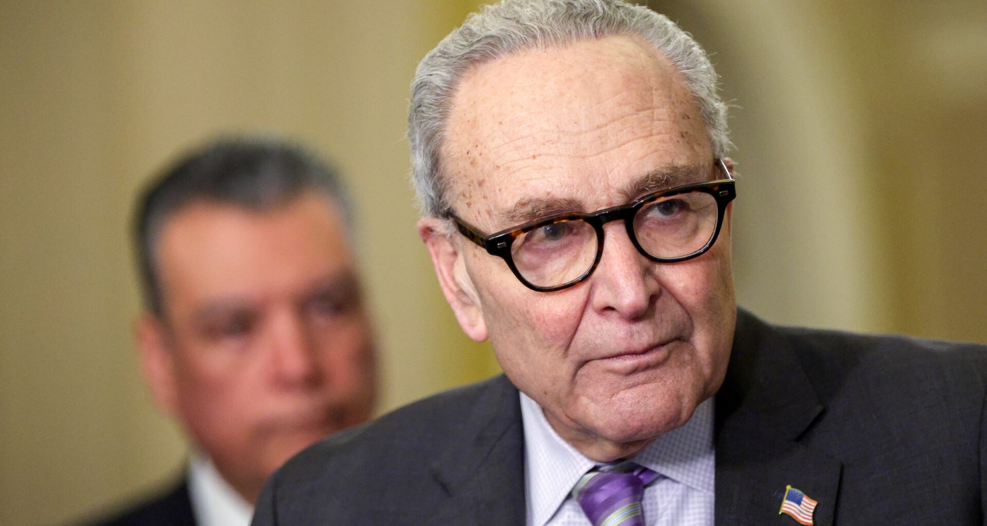 (R-L) U.S. Senate Minority Leader Sen. Chuck Schumer (D-NY) speaks as Sen. Alex Padilla (D-CA) listens during a news briefing on March 24, 2026 in Washington, D.C.