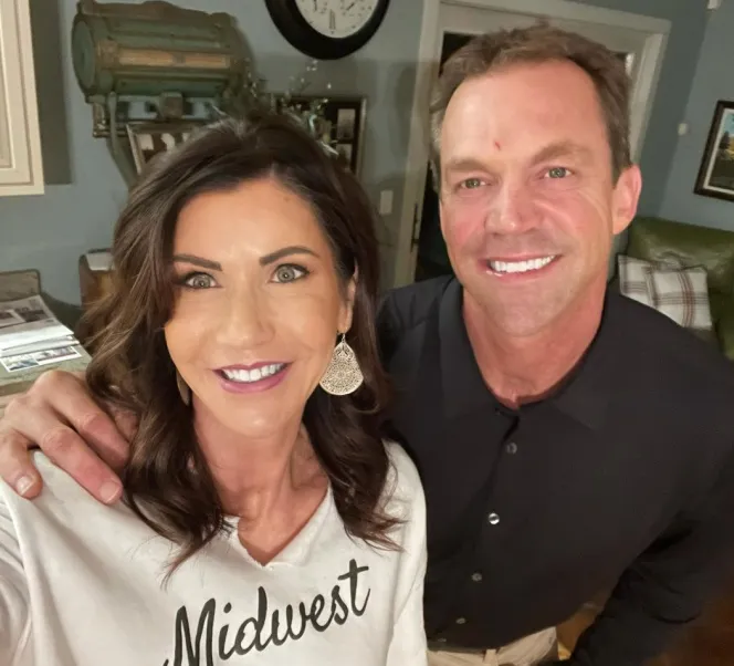 Governor Kristi Noem and her husband Bryon smiling at the camera.