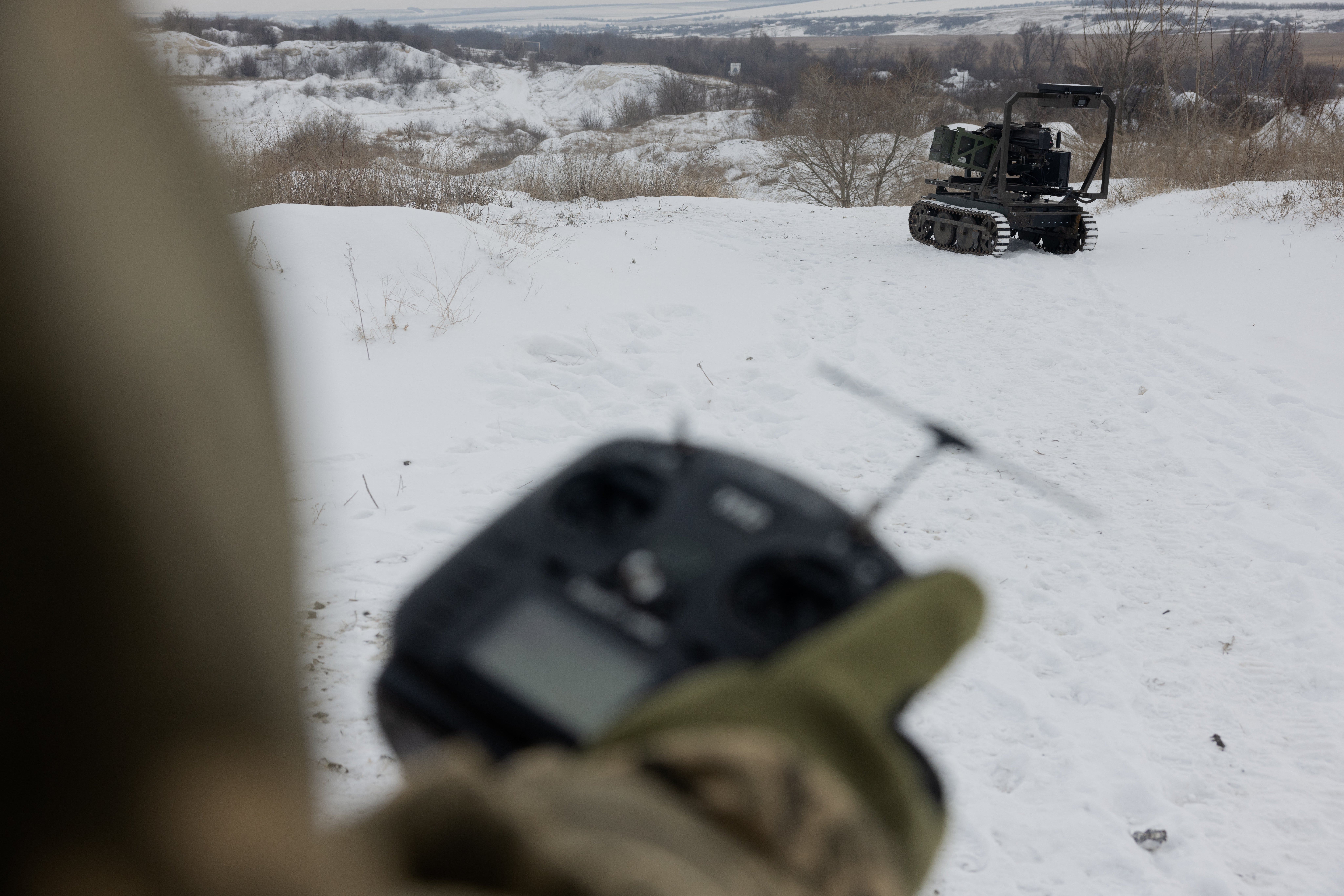 A Ukrainian serviceman tests an unmanned robotic ground vehicle armed with an Mk 19 grenade launcher