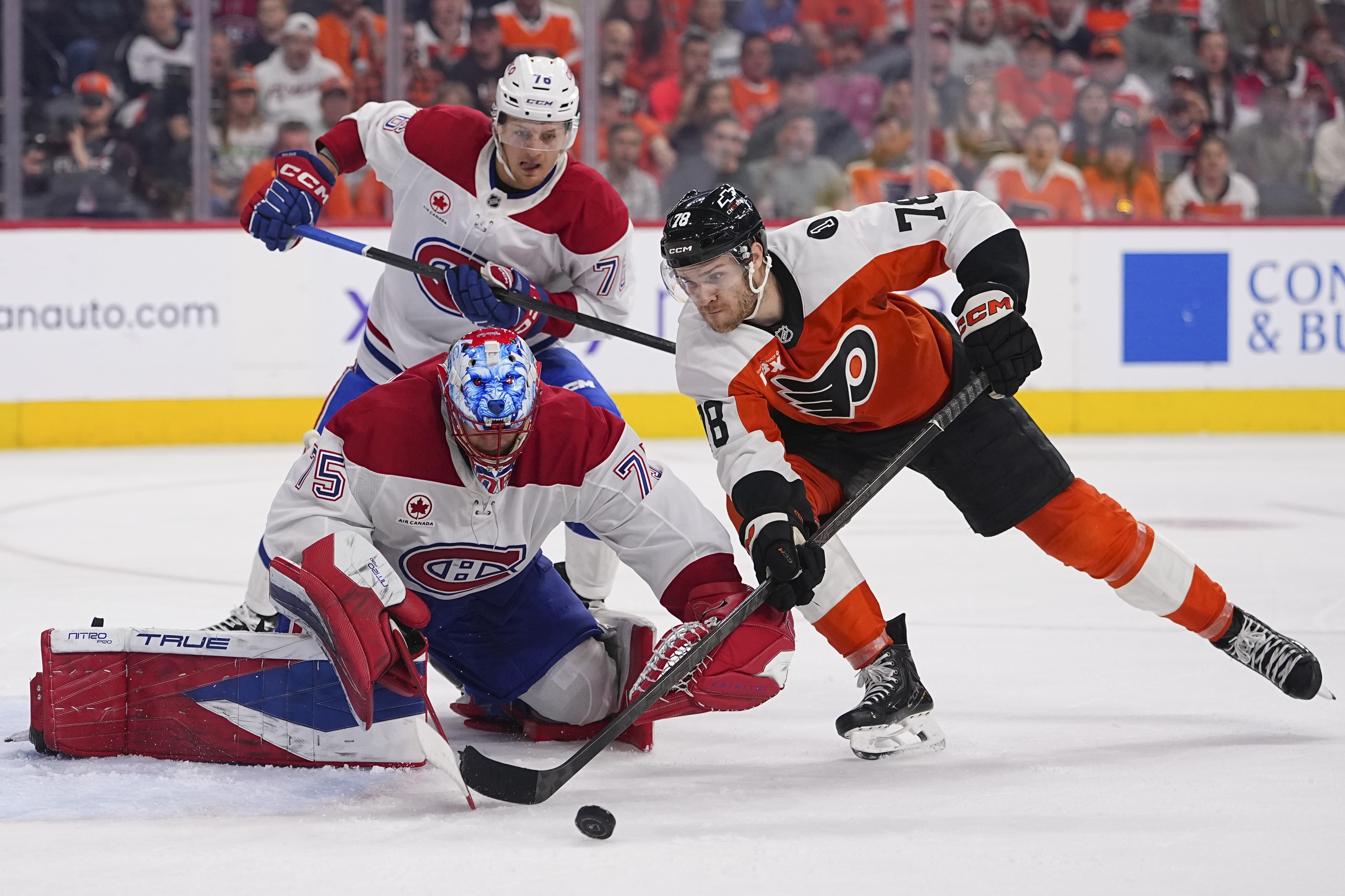 Jacob Gaucher #78 of the Philadelphia Flyers battles with Jakub Dobes #75 of the Montreal Canadiens