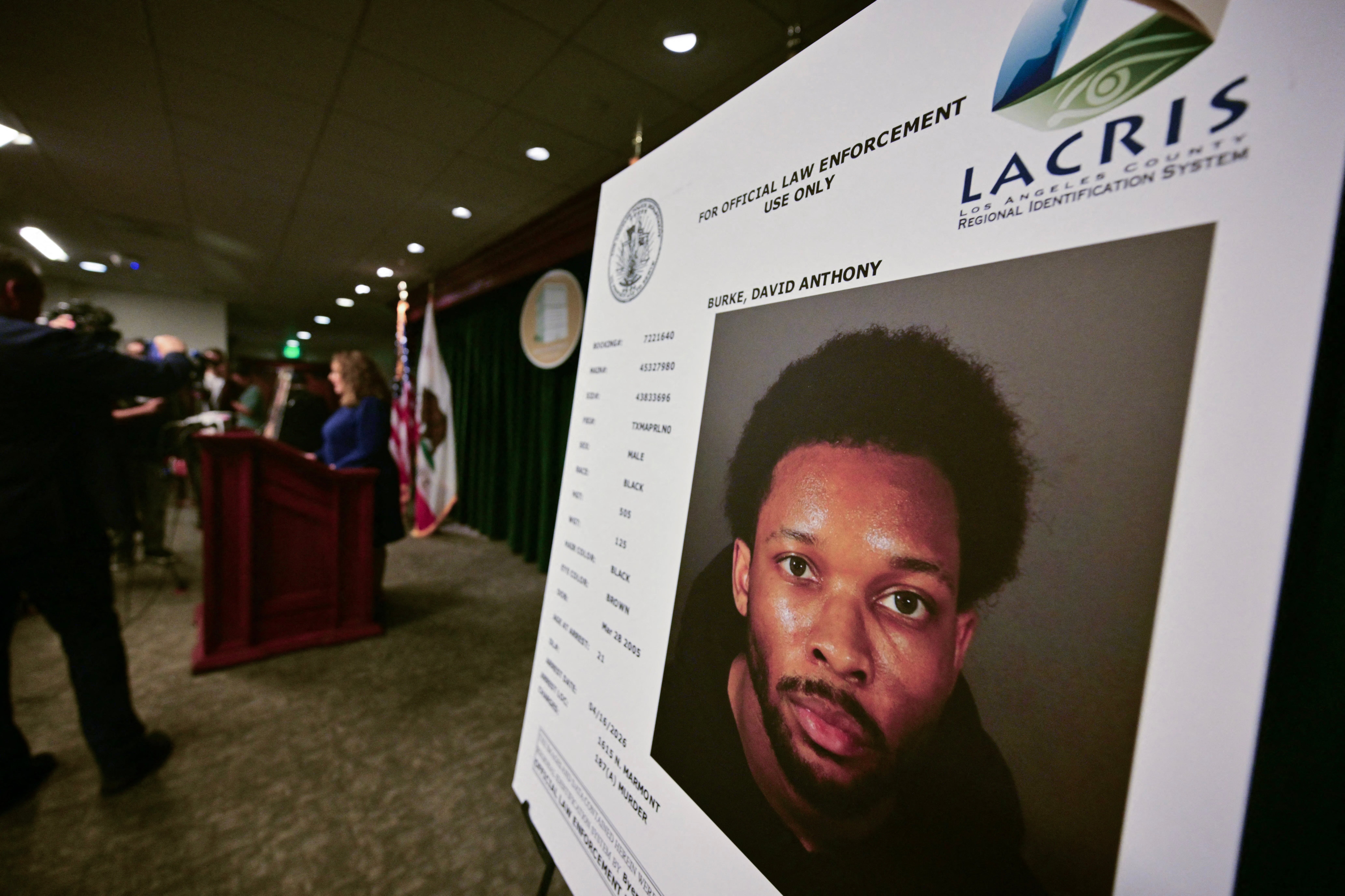 A picture of singer D4vd is seen during a press briefing on the case against him in Los Angeles on April 20, 2026. Rising star D4vd, whose real name is David Burke, was arrested in connection to the murder of a teenage girl whose dismembered body was found in the trunk of a car registered in the artist's name, police said on April 16.