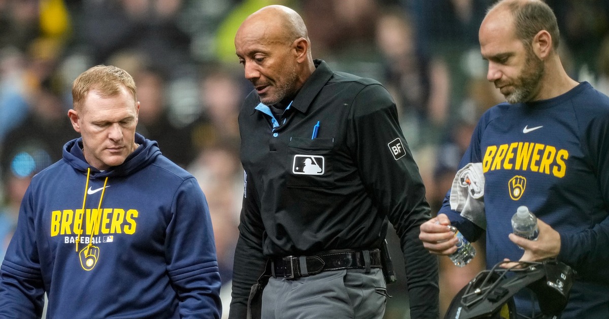 MLB umpire C.B. Bucknor leaves the game after taking foul ball to the face
