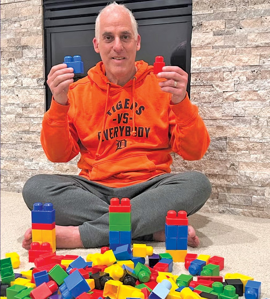 Rabbi Josh Bennett of Temple Israel in Detroit holds Lego blocks, urging families to add the children’s toy to their Seder plates in the wake of a recent attack on the synagogue. – Facebook