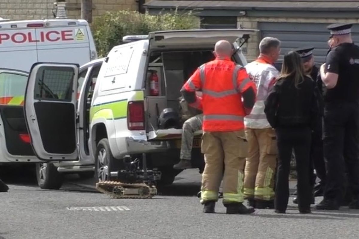 Bomb disposal specialists at the scene with police