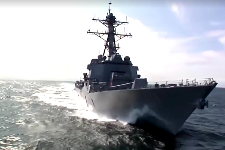 Navy ship sails on ocean