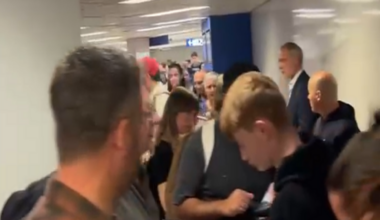 Image shows long queues of people at Milan airport.