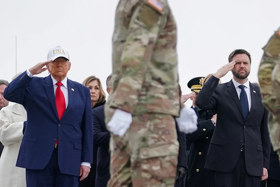 Trump, in a baseball cap, and Vice President JD Vance salute during a dignified transfer of the remains of six U.S. Army service members killed in Iran. / Nathan Howard / Nathan Howard/REUTERS