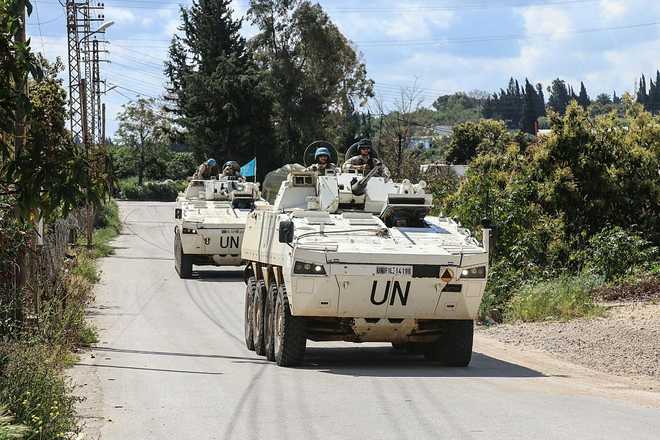 Members of the UN peacekeeping force in Lebanon (UNIFIL), in armored vehicles, patrol the road of the southern Lebanese village of Tair Debba on April 12, 2026. Dozens of countries contributing troops to the UN peacekeeping force in Lebanon called on April 9, 2026, for a cessation of hostilities, after three blue helmets were killed as Israel and Hezbollah traded strikes. (Photo by Kawnat HAJU / AFP via Getty Images)