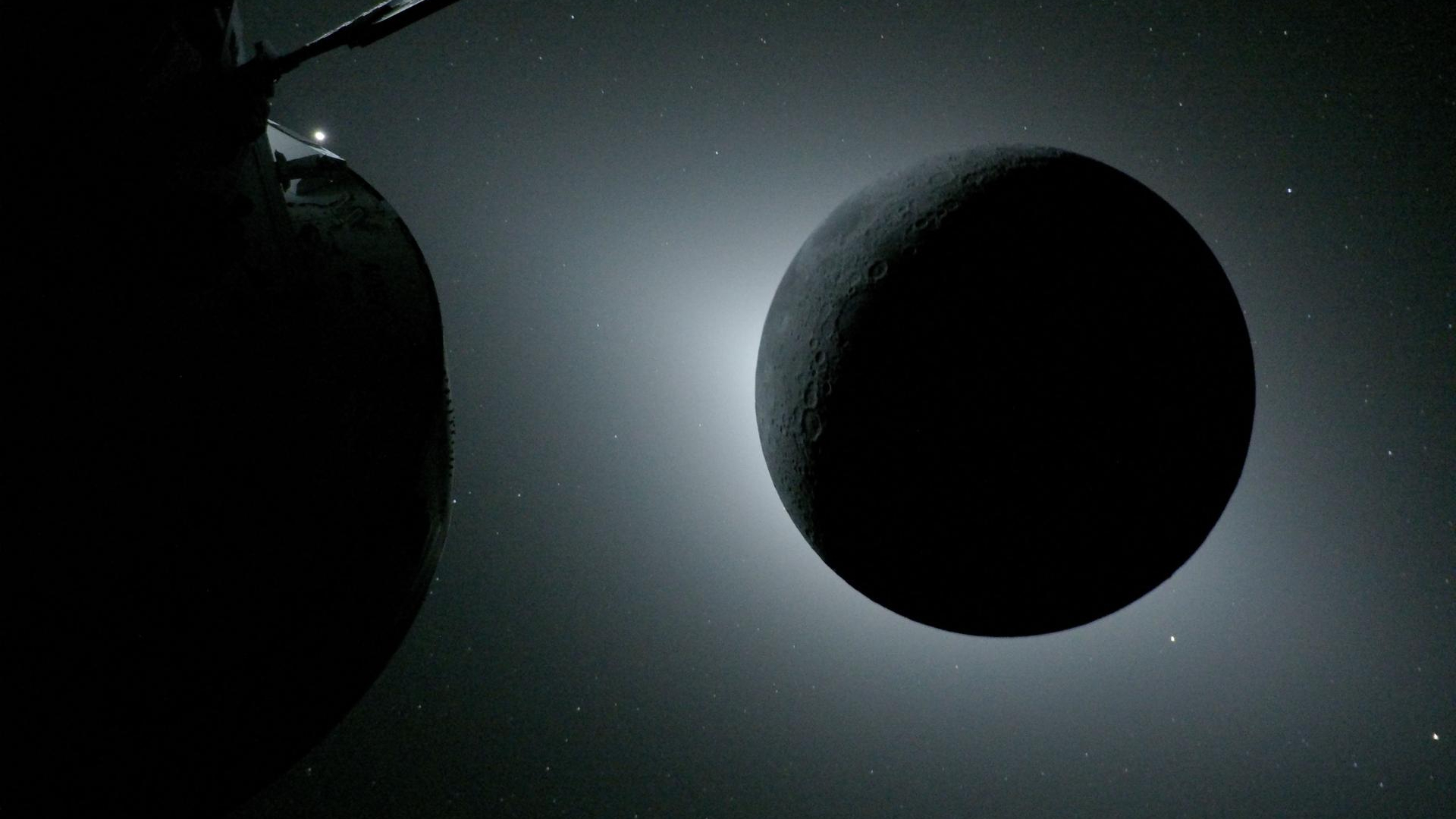 view of a total solar eclipse from a spacecraft near the moon. part of the spacecraft is visible in the foreground