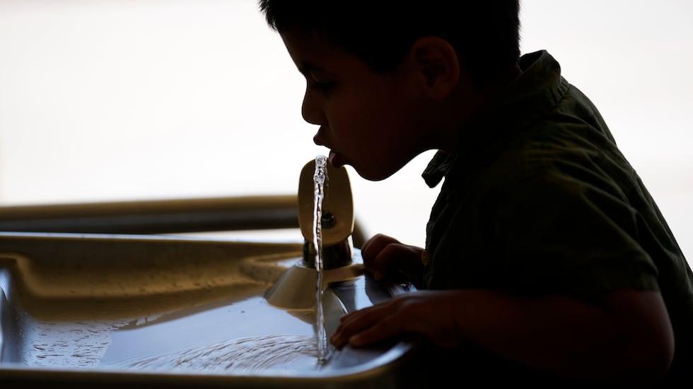 FILE - A student drinks from a water fountain inside Cuyama Elementary School, Sept. 20, 2023,...