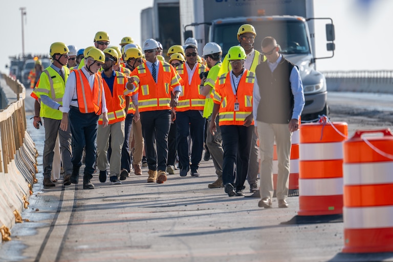 Maryland Governor Wes Moore and other politicians walk down the southwest ramp to the Francis Scott Key Bridge following a tour of the demolition site.