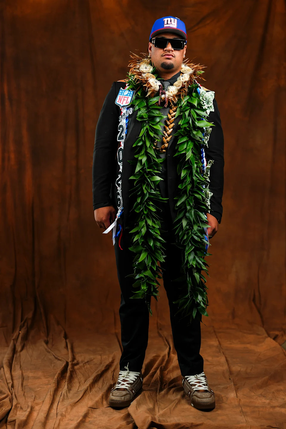 Miami offensive lineman Francis Mauigoa poses for a studio portrait  with traditional Samoan attire during the 2026 NFL Draft in Pittsburgh.