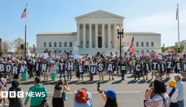 Demonstrators hold letters making up the slogan "Born in the USA = citizen!" outside the U.S. Supreme Court building