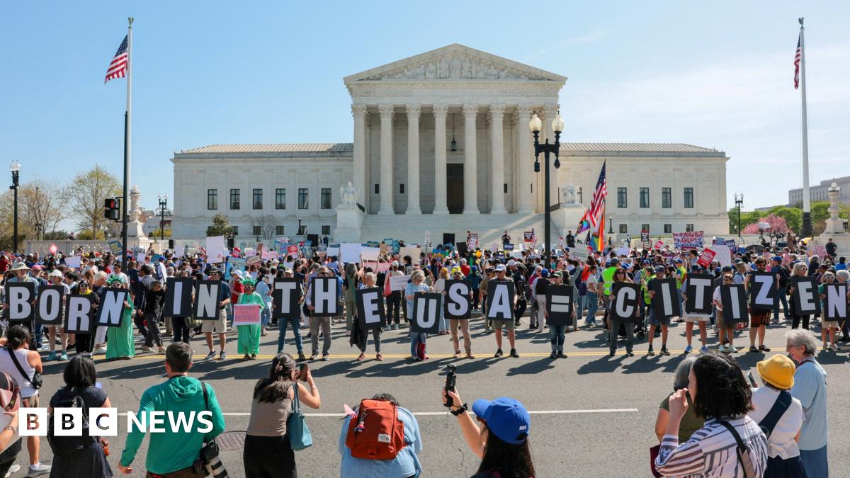 Demonstrators hold letters making up the slogan "Born in the USA = citizen!" outside the U.S. Supreme Court building