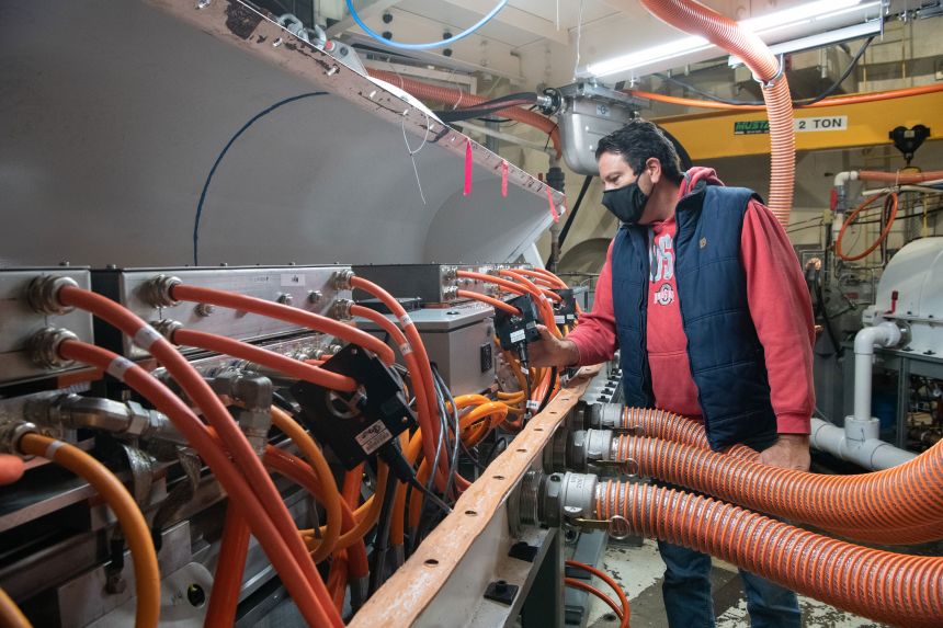 NASA Research Lab Mechanic Sage Amato inspects hybrid-electric components and cables in NASA’s Electrified Testbed (NEAT) facility, as part of the EPFD program, in Sandusky, Ohio in 2021.