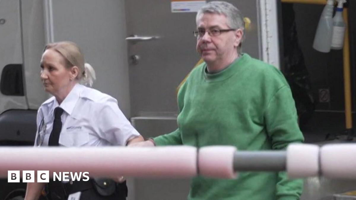 Christopher Phillips arriving outside Cardiff Crown Court. He is handcufgfed to a prison officer