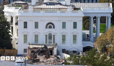 The White House with a wrecker machine out front, on a pile of rubble