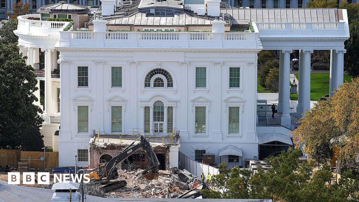 The White House with a wrecker machine out front, on a pile of rubble