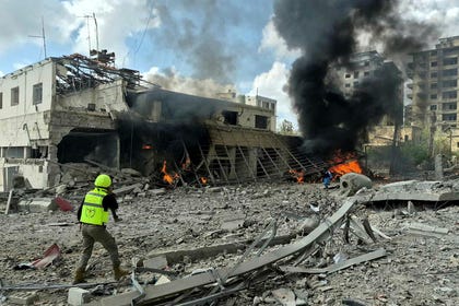 First responders rush to the site of an Israeli airstrike that targeted the Lebanese State Security Center, in the Southern Lebanese city of Nabatieh, on Friday. Credit: AFP/ABBAS FAKIH First responders rush to the site of an Israeli airstrike that targeted the Lebanese State Security Center, in the Southern Lebanese city of Nabatieh, on Friday.