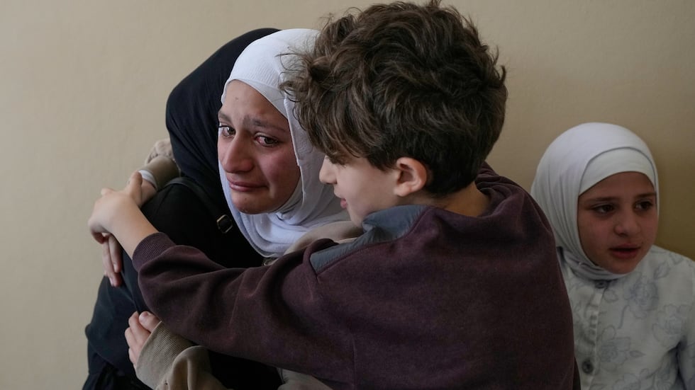Relatives of Ghadir Baalbaki, 19, who was killed on Tuesday in an Israeli airstrike, mourn...