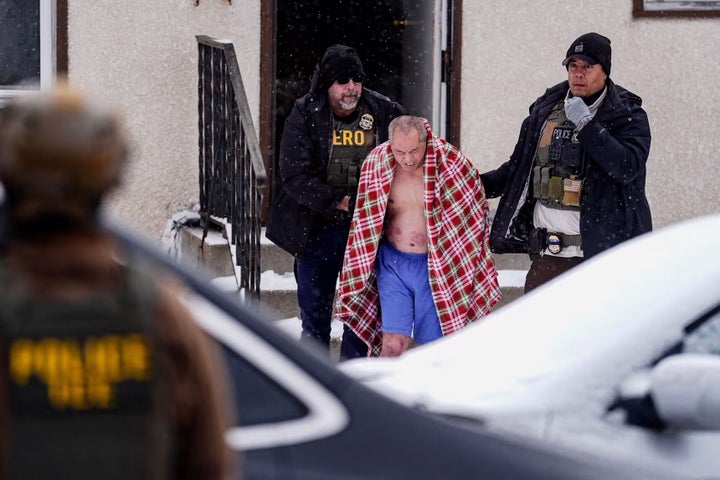 ChongLy Thao is detained in an immigration raid at his home Sunday in St. Paul, Minn.