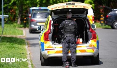 Police officers patrol at a cordon near to an incident at the Kenton United Synagogue in Harrow