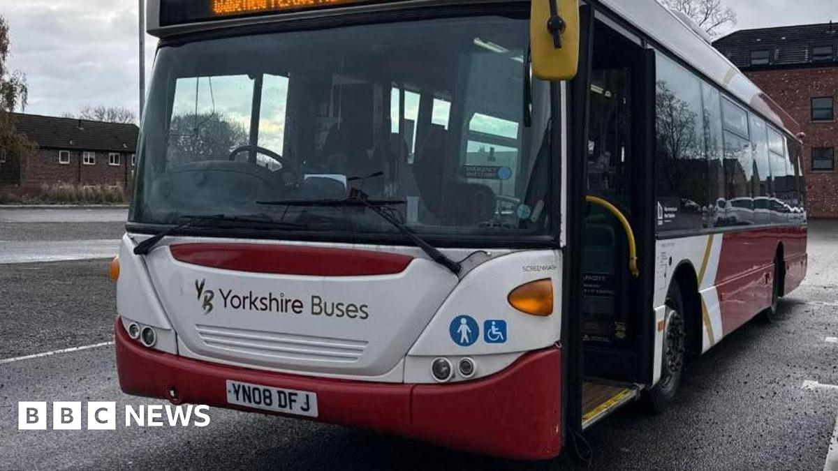 A parked bus owned by firm Yorkshire Buses in a red and white livery.