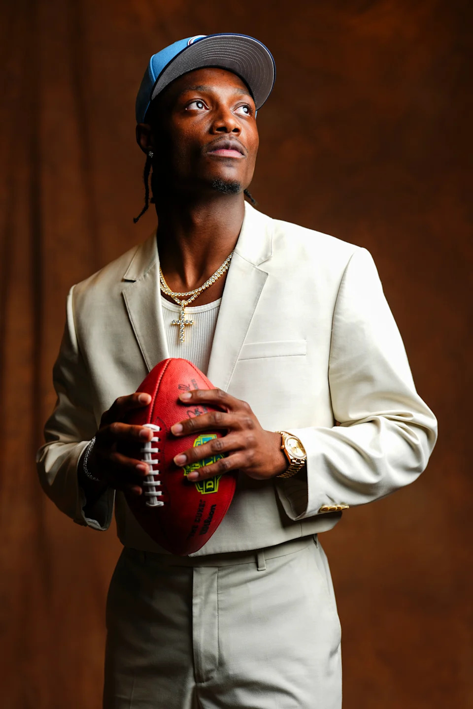 Tate wore a cropped cream suit jacket and traded his Chill for a cross.