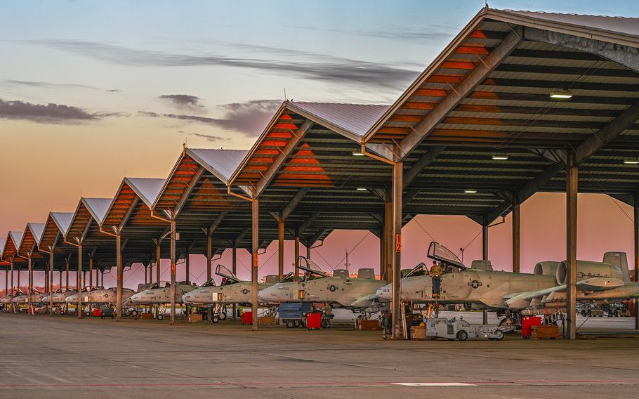 The aircraft sit under canopies.