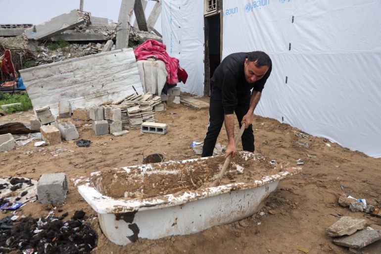 Man mixes mud with hair in a bathtub