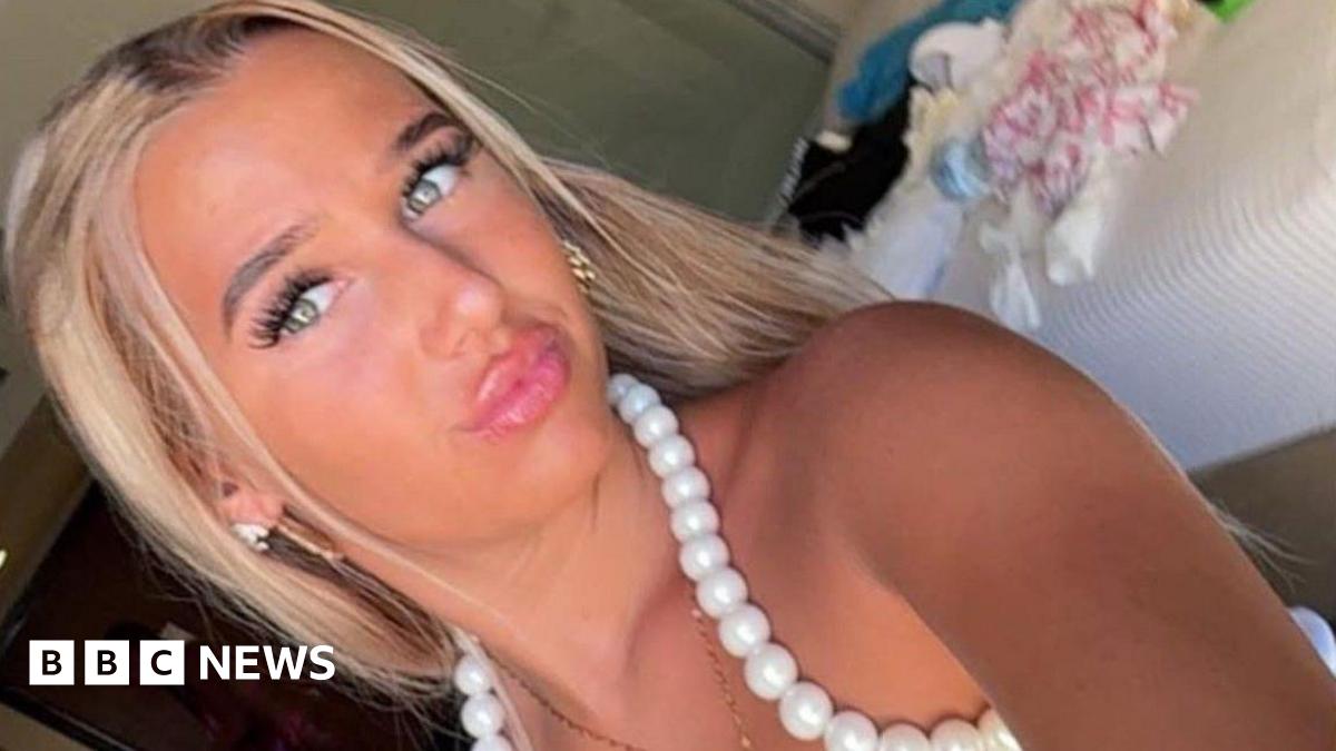 Chloe Watson Dransfield is pictured looking directly at the camera and pouting. She has long, blonde hair and is wearing a white top with beading around the neck line.