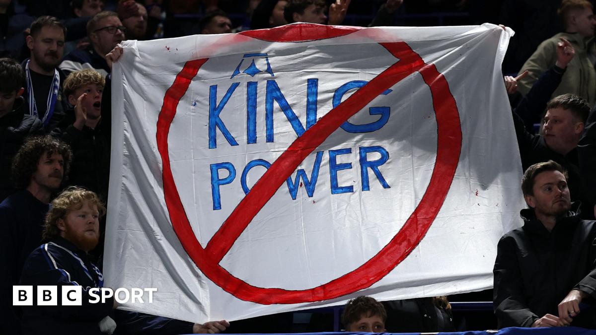 A sign is held by some Leicester City fans in protest of the club's ownership