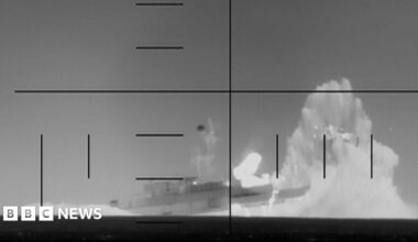 A map showing the Arabian Sea region including Iran, Oman, Saudi Arabia, India, and Sri Lanka. A red label near Sri Lanka marks the location where the Iris Dena sank near Galle. The Strait of Hormuz is labelled between Iran and Oman. In the upper-right corner, an inset photo shows a grey naval ship docked at a port with cranes in the background, labelled the Iris Dena in Brazil in 2023. A small world map in the upper-left highlights the region with a red rectangle.