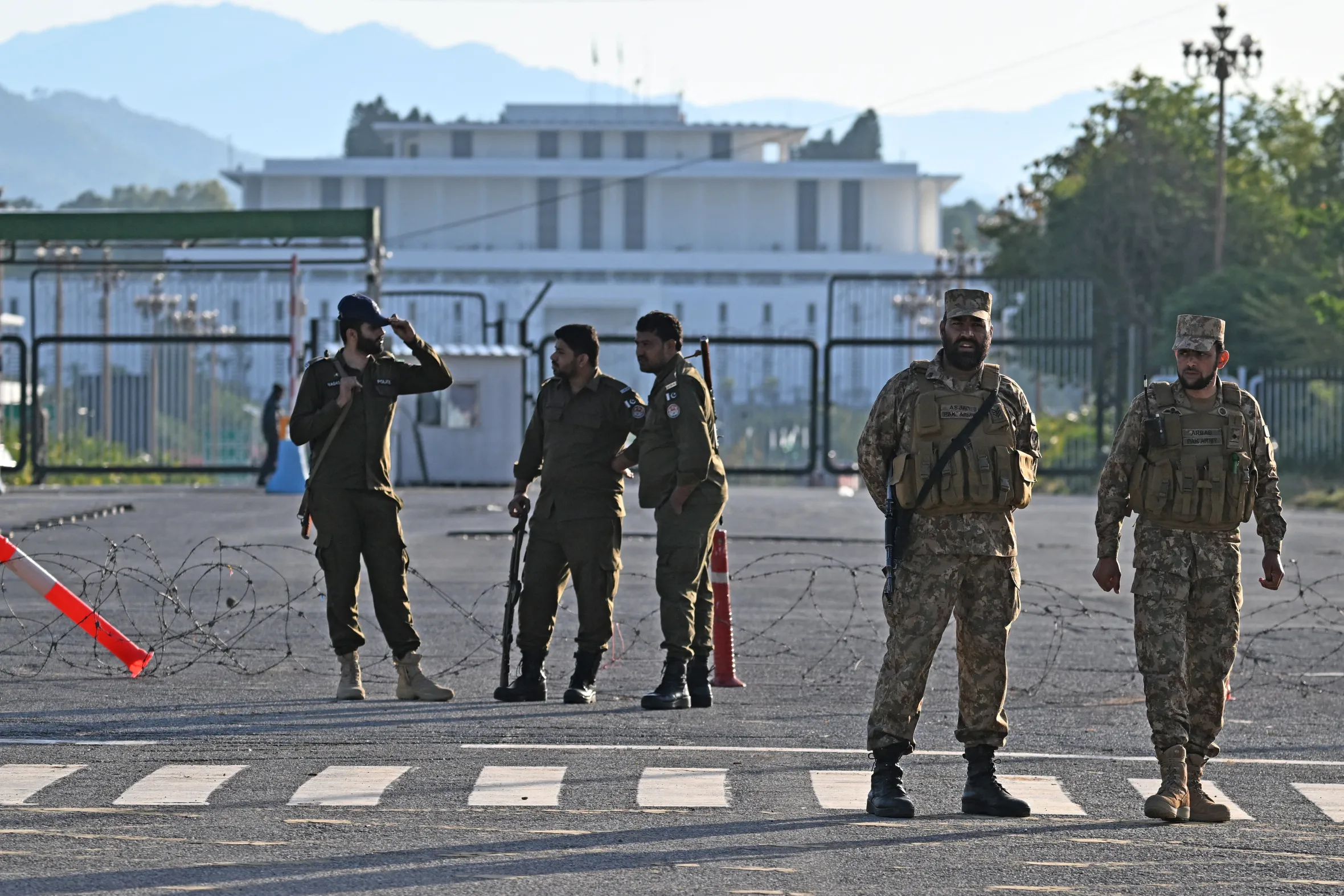 Pakistani soldiers and police officers stand guard near the President House in Islamabad.