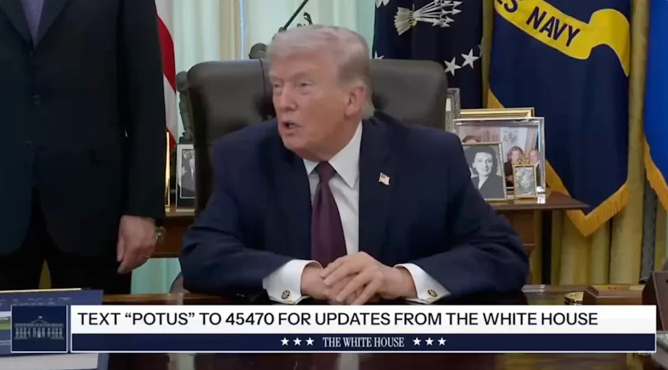 A person at a desk in a formal setting speaks; text below provides a number to text for White House updates