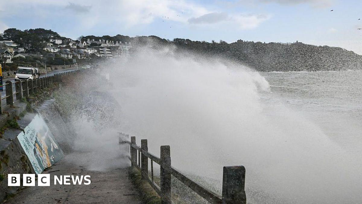 A wave crashing over a sea wall