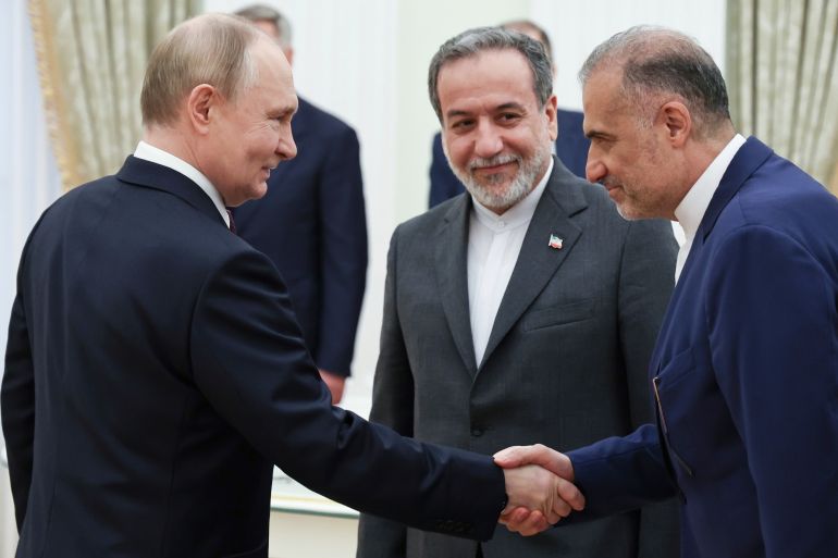 Russian President Vladimir Putin, left, greets Ambassador of Iran to Russia Kazem Jalali, right, and Iranian Foreign Minister Abbas Araghchi, center, prior to their talks at the Kremlin in Moscow, Russia, Monday, June 23, 2025.