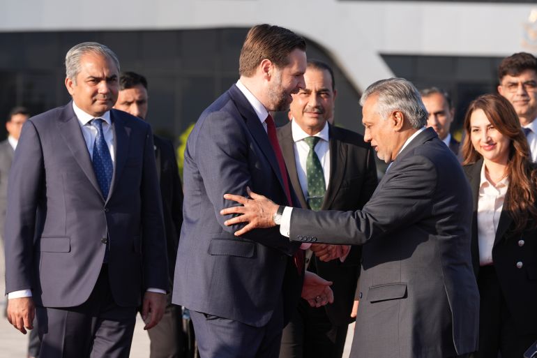 Vice President JD Vance, second left, shakes hands with Pakistani Deputy Prime Minister and Foreign Minister Mohammad Ishaq Dar, as Pakistan's Interior Minister Mohsin Naqvi, left, Pakistan's Chief of Defence Forces Chief of Army Staff Field Marshall Asim Munir, third left, and Charge d'Affaires of the U.S. Embassy in Islamabad Natalie A. Baker, right, look on, as he prepares to board Air Force Two