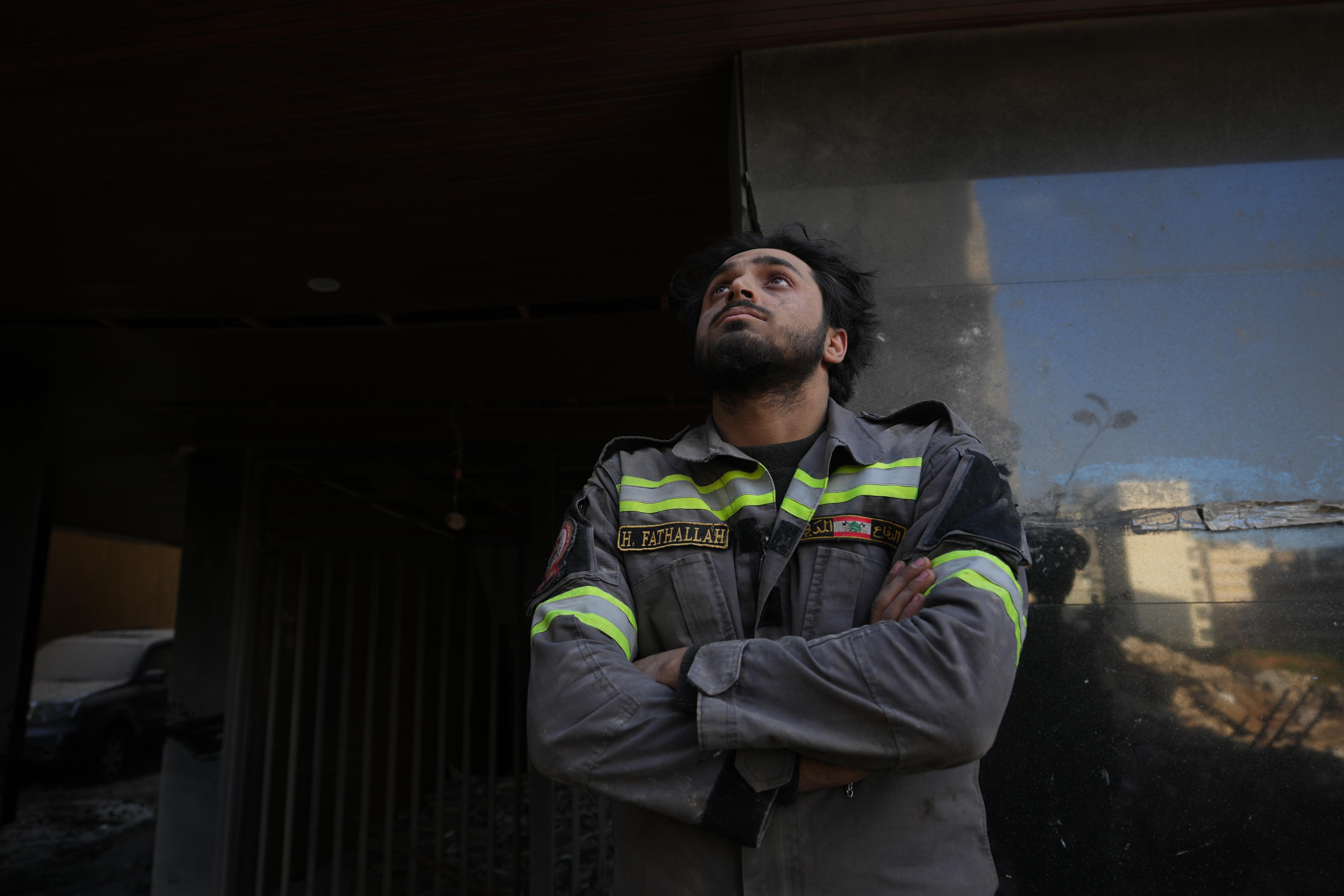 A Lebanese civil defense worker looks near the site of a building destroyed in an Israeli airstrike.
