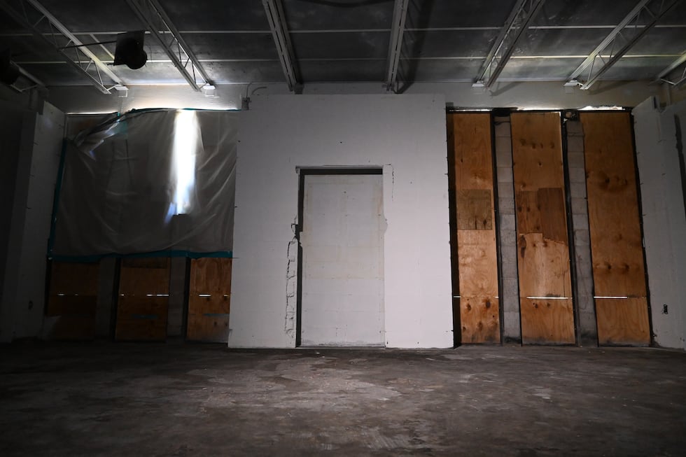 Wooden boards and plastic close off windows inside the library of the Beth Israel Congregation...