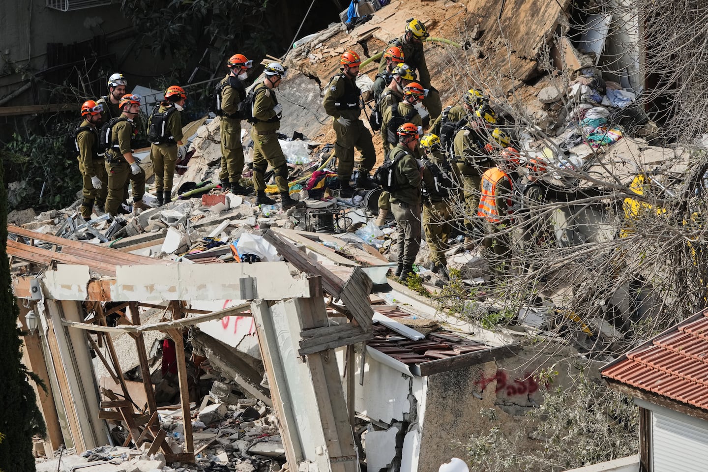 Israeli rescue teams search for missing people amid the rubble of a residential building a day after it was struck by an Iranian missile in Haifa, Israel, on April 6.
