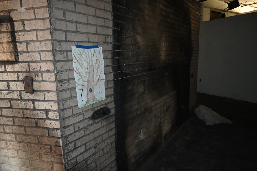 A painting of a tree hangs next to where the former Tree of Life Memorial was located at Beth...